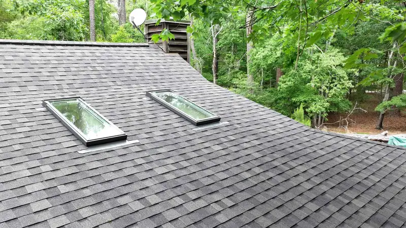 Two skylights set into a grey asphalt shingle roof, installed by Chief Roofing in North Carolina